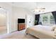 Spacious main bedroom featuring a ceiling fan, access to the main bath, and a window with natural light at 3303 Timbercreek Cir, Roswell, GA 30076