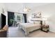 Spacious main bedroom featuring a ceiling fan, a decorative chair and a window with natural light at 3303 Timbercreek Cir, Roswell, GA 30076