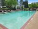 Large swimming pool with lounge chairs and well-maintained landscaping within a residential community at 3303 Timbercreek Cir, Roswell, GA 30076