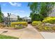 Community pool entrance with beautiful landscaping, colorful flowers, and a relaxing ambiance at 3303 Timbercreek Cir, Roswell, GA 30076