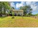 Large backyard featuring a grassy lawn with mature trees at 745 Beaver Pond Trl, Fairburn, GA 30213