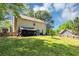 Spacious backyard with lush green grass, mature trees, and partial fence at 745 Beaver Pond Trl, Fairburn, GA 30213