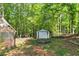 View of the shed in a wooded backyard at 745 Beaver Pond Trl, Fairburn, GA 30213
