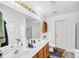 Bathroom with double sink vanity, large mirror, and tile floor at 745 Beaver Pond Trl, Fairburn, GA 30213