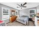 Comfortable bedroom featuring a ceiling fan and natural light from the windows at 745 Beaver Pond Trl, Fairburn, GA 30213
