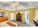 Bright primary bedroom with ceiling fan, bed, and two door to other rooms at 745 Beaver Pond Trl, Fairburn, GA 30213