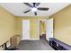 Empty bedroom with ceiling fan, two doors, and minimal furniture at 745 Beaver Pond Trl, Fairburn, GA 30213