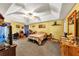 Primary bedroom with neutral walls, ceiling fan and a large bed at 745 Beaver Pond Trl, Fairburn, GA 30213