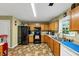View of the eat-in kitchen featuring black appliances and light brown cabinetry at 745 Beaver Pond Trl, Fairburn, GA 30213