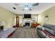 Cozy living room featuring a fireplace and ceiling fan at 745 Beaver Pond Trl, Fairburn, GA 30213