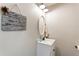 Bathroom with a white vanity, sink, toilet, and decorative wall art at 2293 Baker Station Dr, Acworth, GA 30101