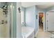 Bright bathroom shows a soaking tub, glass shower, and neutral walls, offering a serene bathing experience at 2293 Baker Station Dr, Acworth, GA 30101