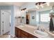 Light and bright bathroom featuring double sinks, wood vanity, and large mirror at 2293 Baker Station Dr, Acworth, GA 30101