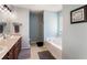 Serene bathroom features a dual vanity, soaking tub, shower, and neutral tile flooring at 2293 Baker Station Dr, Acworth, GA 30101