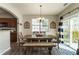 Dining room featuring rustic wooden table and bench set with backyard access at 2293 Baker Station Dr, Acworth, GA 30101