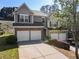 Beautiful two-story townhome with brick accents, a two-car garage, and lush landscaping at 2293 Baker Station Dr, Acworth, GA 30101