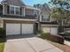 Attractive townhome featuring a two-car garage, brick facade, and neatly trimmed bushes at 2293 Baker Station Dr, Acworth, GA 30101
