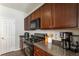 The kitchen features stainless appliances, granite countertops, and dark wood cabinets at 2293 Baker Station Dr, Acworth, GA 30101