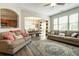 Open concept living room with connecting dining room, lots of natural light, and plush sofas at 2293 Baker Station Dr, Acworth, GA 30101