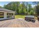 Backyard deck features a modern hot tub, outdoor seating, and lush greenery for relaxation at 2710 Hayden Dr, East Point, GA 30344