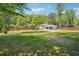 Spacious backyard featuring a well-maintained lawn, wood fence, and charming outdoor seating area, perfect for entertaining at 2710 Hayden Dr, East Point, GA 30344