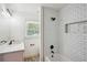 Bright bathroom showcasing subway tile walls, modern fixtures, and a shower-tub combination at 2710 Hayden Dr, East Point, GA 30344