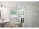 Bathroom featuring wood-look tile flooring and a glass enclosed shower with decorative accent tile at 2710 Hayden Dr, East Point, GA 30344
