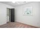 Bright bedroom featuring carpet, a large window, and a closet with built-in shelving at 2710 Hayden Dr, East Point, GA 30344