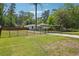 Well-maintained home with a large yard, mature trees, and a secure black metal fence at 2710 Hayden Dr, East Point, GA 30344