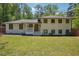 Charming renovated single-Gathering home featuring a freshly painted exterior and lush front lawn at 2710 Hayden Dr, East Point, GA 30344