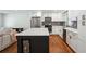 Beautiful kitchen features stainless steel appliances, white cabinets, and an island with bar seating at 2710 Hayden Dr, East Point, GA 30344
