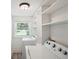 Well-lit laundry room featuring a modern washer and dryer and built in storage at 2710 Hayden Dr, East Point, GA 30344