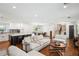 Open-concept living room showcasing hardwood floors, a modern kitchen, and access to dining area at 2710 Hayden Dr, East Point, GA 30344