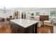 Open-concept living area with hardwood floors, a center island, and lots of natural light at 2710 Hayden Dr, East Point, GA 30344