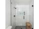 Modern shower featuring gray tile flooring, white subway tile, glass surround, and bench at 2710 Hayden Dr, East Point, GA 30344