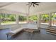 Sunroom with slate tile, white brick accent wall, and backyard views from the large windows at 2710 Hayden Dr, East Point, GA 30344