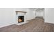 Finished basement with wood-look floors and a classic white-brick fireplace at 335 Amberidge Trl, Atlanta, GA 30328