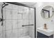 Modern bathroom featuring a tiled shower with glass door and a vanity with gold fixtures at 335 Amberidge Trl, Atlanta, GA 30328