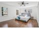 Bright bedroom featuring hardwood floors, a ceiling fan, and natural light from dual windows at 335 Amberidge Trl, Atlanta, GA 30328