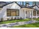 Inviting white brick facade with black trim and stone walkway leading to the front door at 335 Amberidge Trl, Atlanta, GA 30328