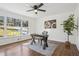 Well-lit home office with large window, hardwood floors, and a modern desk setup at 335 Amberidge Trl, Atlanta, GA 30328