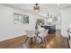 Sunlit dining area with a glass table, modern lighting, and open view to the kitchen with white cabinetry at 335 Amberidge Trl, Atlanta, GA 30328