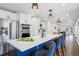 Spacious kitchen island featuring white countertop, blue cabinets, stainless steel appliances, and modern lighting at 335 Amberidge Trl, Atlanta, GA 30328