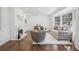 Stylish living room featuring a cozy fireplace, hardwood floors, and modern decor at 335 Amberidge Trl, Atlanta, GA 30328