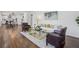 Open-concept living area with hardwood floors, stylish furniture, and a view of the kitchen at 335 Amberidge Trl, Atlanta, GA 30328