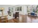 Bright living room with large windows, hardwood floors, stylish furnishings, and access to the outdoors at 335 Amberidge Trl, Atlanta, GA 30328