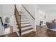 Elegant staircase with hardwood steps and white risers leading to the upper level at 335 Amberidge Trl, Atlanta, GA 30328