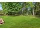 Expansive grassy backyard with mature trees, offering plenty of space for recreation and relaxation at 431 Shore Dr, Suwanee, GA 30024