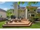 A spacious outdoor deck with a dining table and fire pit for entertaining and outdoor relaxation at 431 Shore Dr, Suwanee, GA 30024