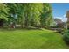 A large backyard with mature trees and expansive lawn provides a peaceful and private setting at 431 Shore Dr, Suwanee, GA 30024